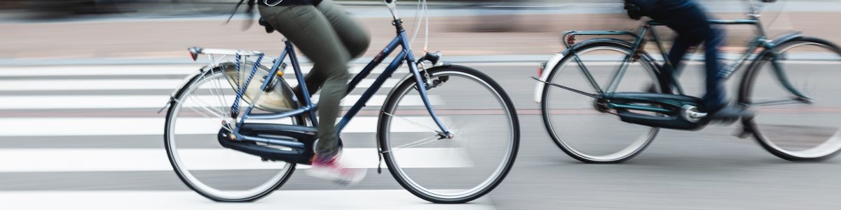 picture with camera made motion blur effect of bicycle riders on a city street
